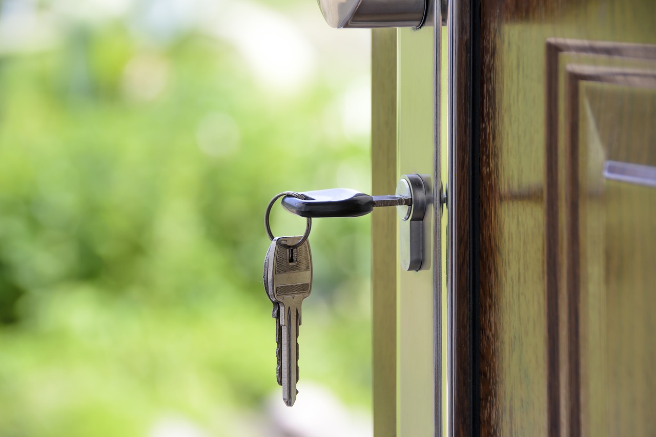 Photo of open front door with key in the lock